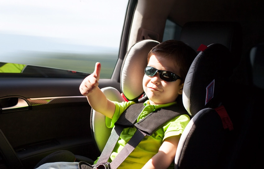 a-boy-sitting-in-a-car-safety-seat-importance-of-road-safety
